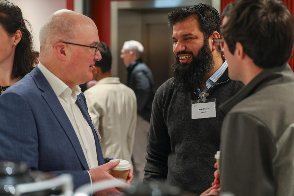 Shows Dr Inam Ul Ahad speaking with attendees