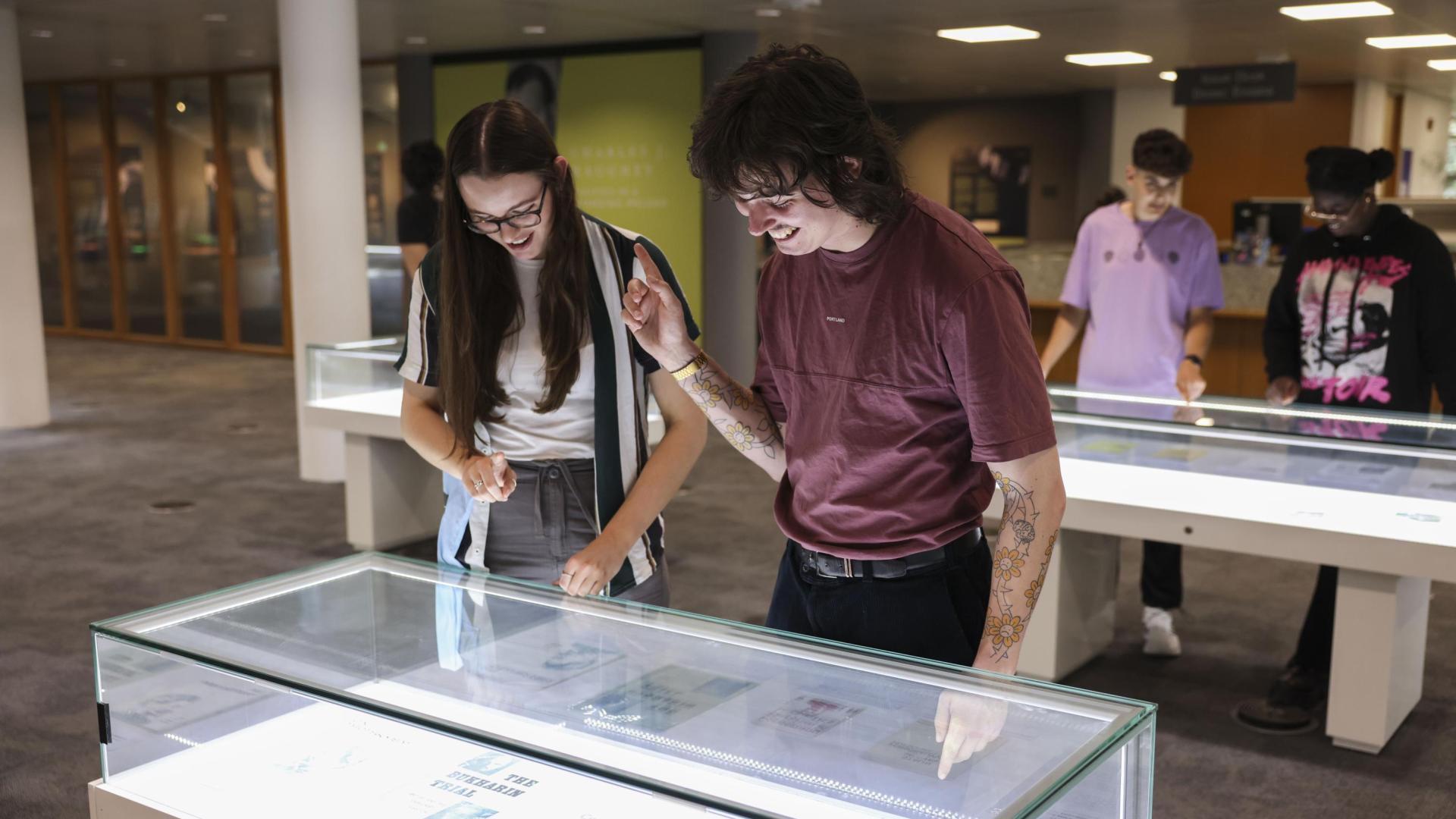 Shows students looking at display in exhibition